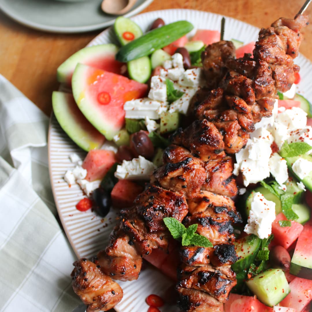 Melon- och fetostsallad med chiliheta karréspett och tzatziki